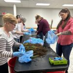 Volunteers Prepare Tree Saplings to Fourth Graders for Earth Day