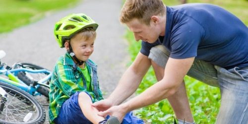 500_scrapedkneeboyonbike